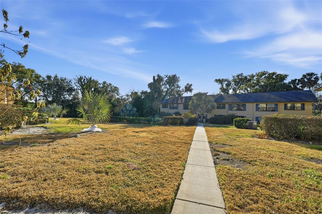 110 North Tremain Street, Unit 109 Mount Dora, FL 32757 - Photo 40 of 45 a view of swimming pool with lawn chairs and large tree