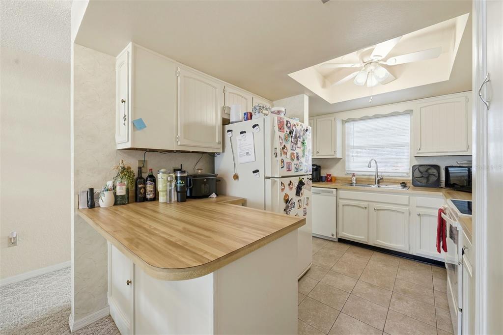 110 North Tremain Street, Unit 109 Mount Dora, FL 32757 - Photo 4 of 45 a kitchen that has a lot of cabinets in it and wooden floors