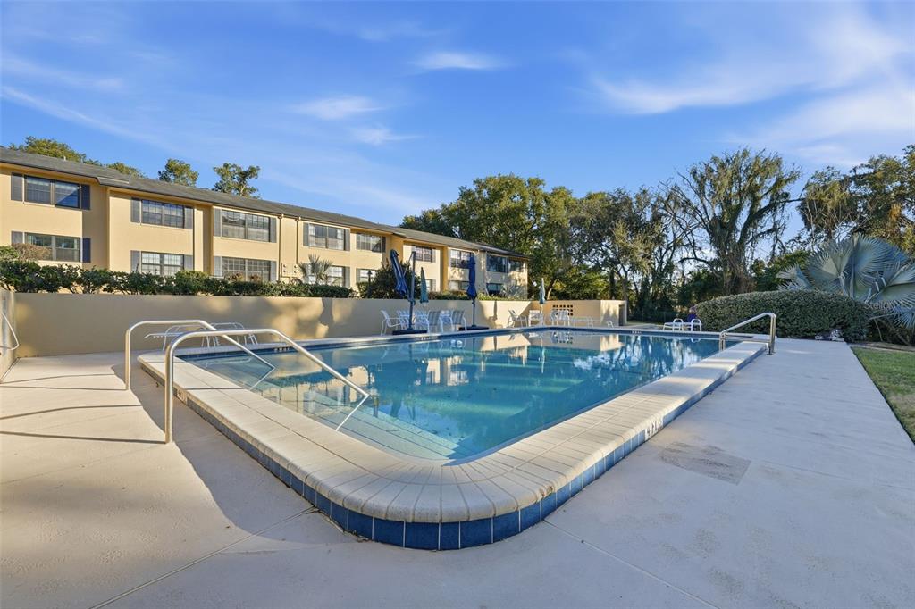 110 North Tremain Street, Unit 109 Mount Dora, FL 32757 - Photo 41 of 45 a view of a swimming pool with lounge chairs