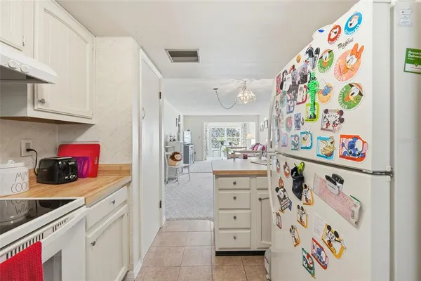 a kitchen with stainless steel appliances granite countertop a stove and white cabinets