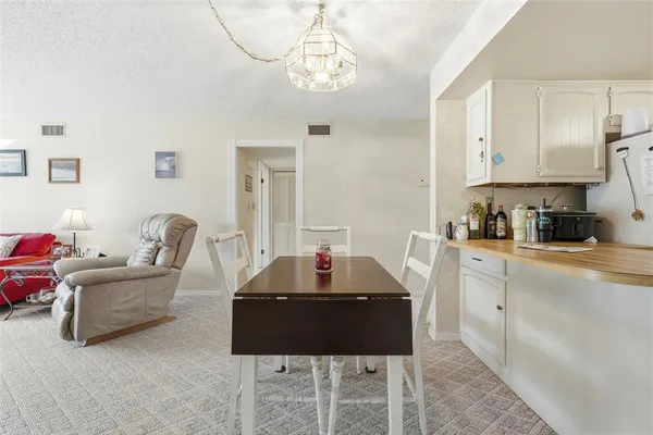 a view of kitchen with furniture and refrigerator
