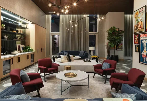 a living room with furniture and large windows