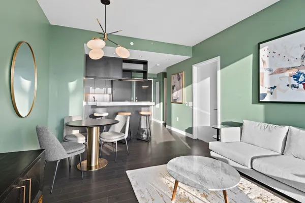 a living room with furniture a lamp and a large window