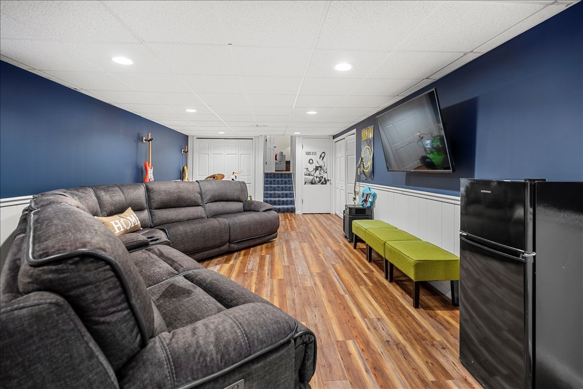 30 South Wulff Street Cary, IL 60013 - Photo 11 of 39 a living room with furniture a flat screen tv and a refrigerator