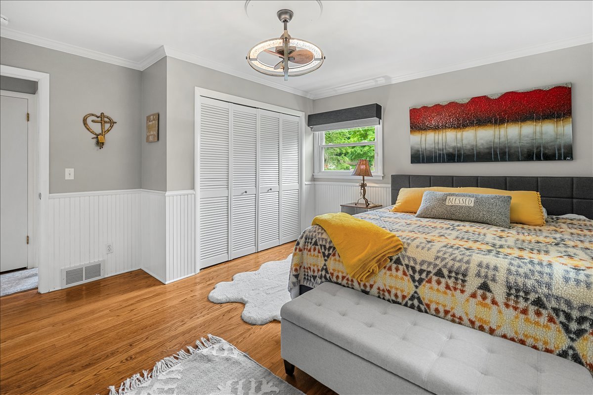 30 South Wulff Street Cary, IL 60013 - Photo 13 of 39 a bedroom with a bed and a chandelier