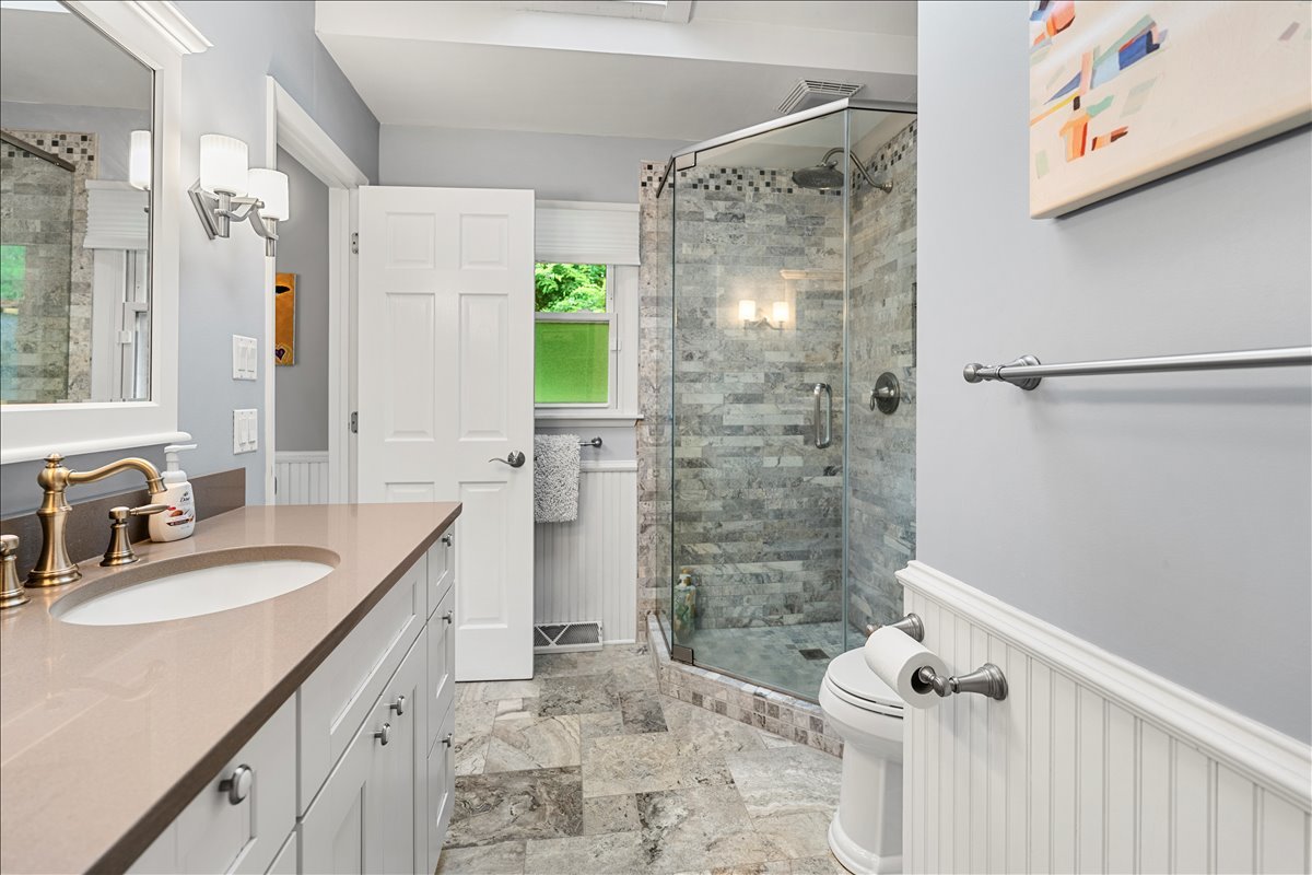 30 South Wulff Street Cary, IL 60013 - Photo 23 of 39 a bathroom with a granite countertop sink a mirror a shower and a toilet