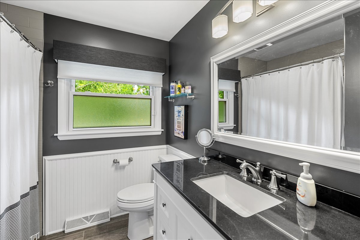 30 South Wulff Street Cary, IL 60013 - Photo 24 of 39 a bathroom with a toilet a sink a mirror and a window