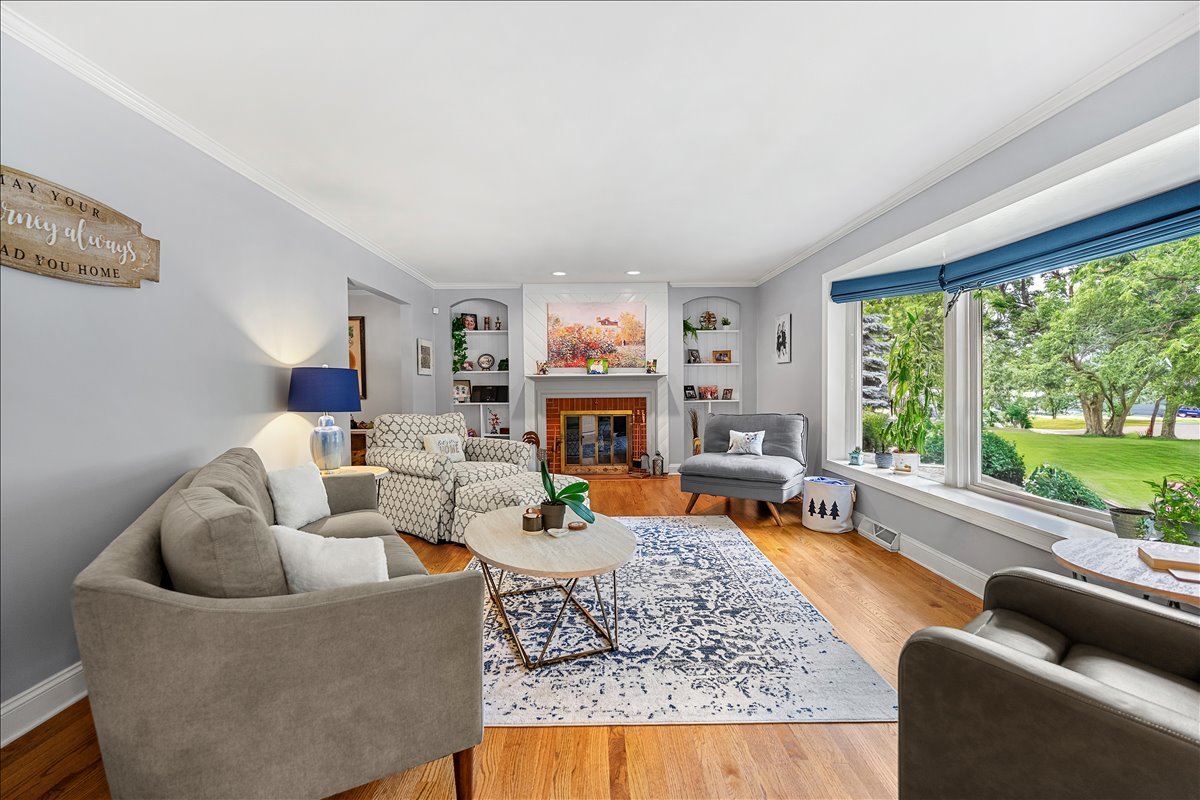 30 South Wulff Street Cary, IL 60013 - Photo 7 of 39 a living room with furniture large window and a fireplace