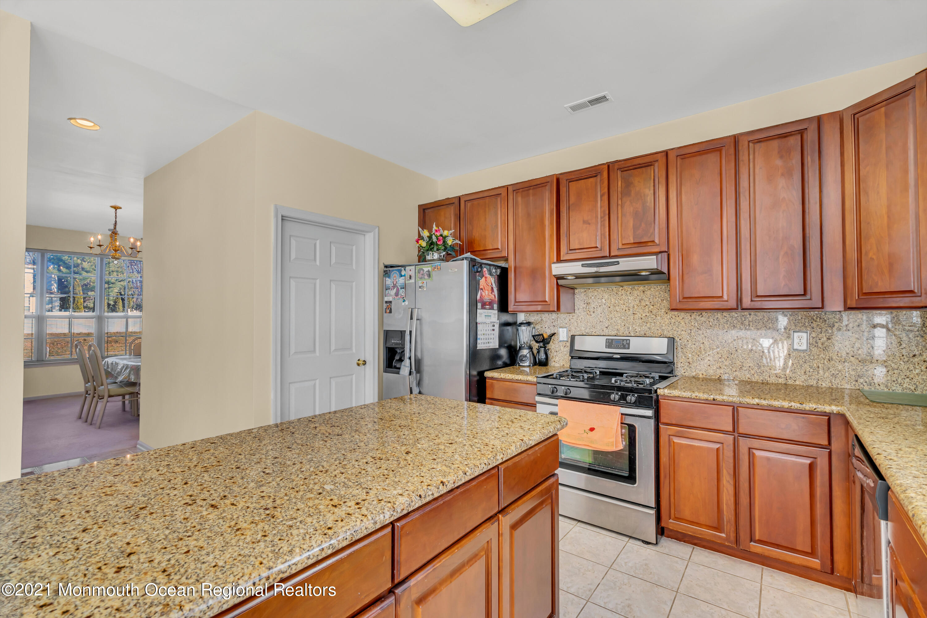 20 Lancaster Way Jackson, NJ 08527 - Photo 13 of 58 a kitchen with stainless steel appliances granite countertop a stove a sink and a refrigerator