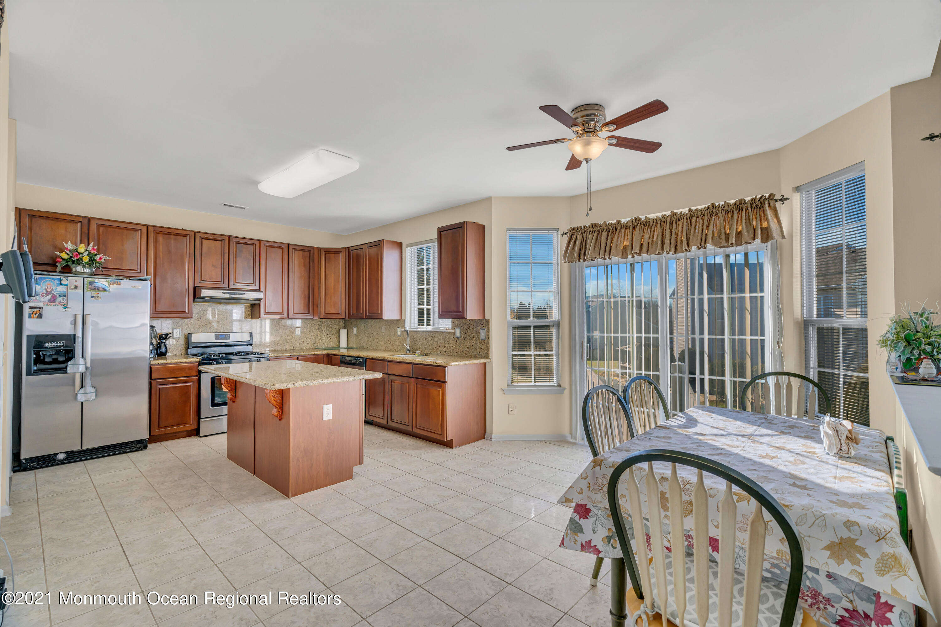 20 Lancaster Way Jackson, NJ 08527 - Photo 21 of 58 a kitchen with stainless steel appliances granite countertop a stove a sink dishwasher and a refrigerator with wooden cabinets