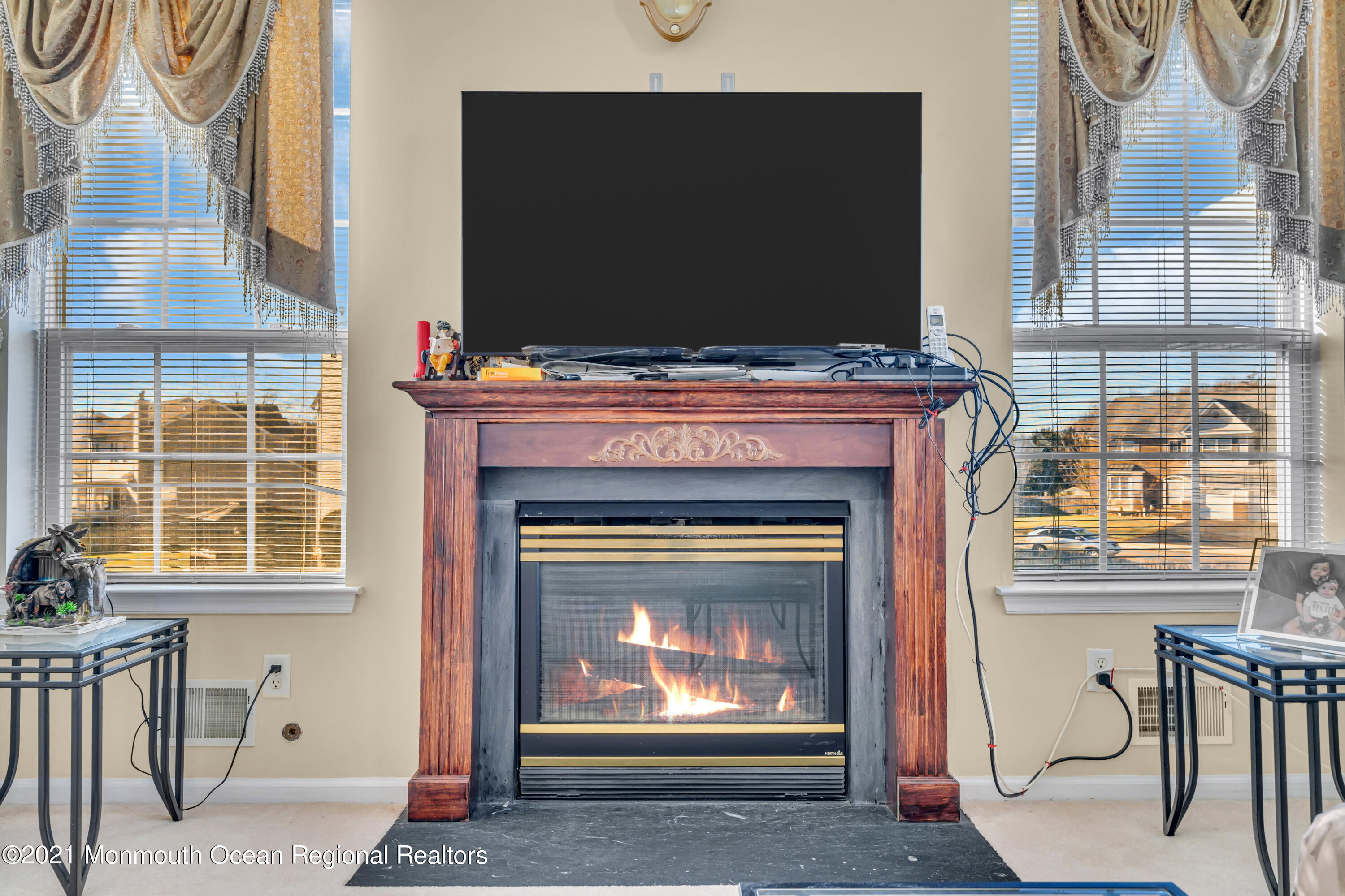 20 Lancaster Way Jackson, NJ 08527 - Photo 27 of 58 a living room with a fireplace and a flat screen tv