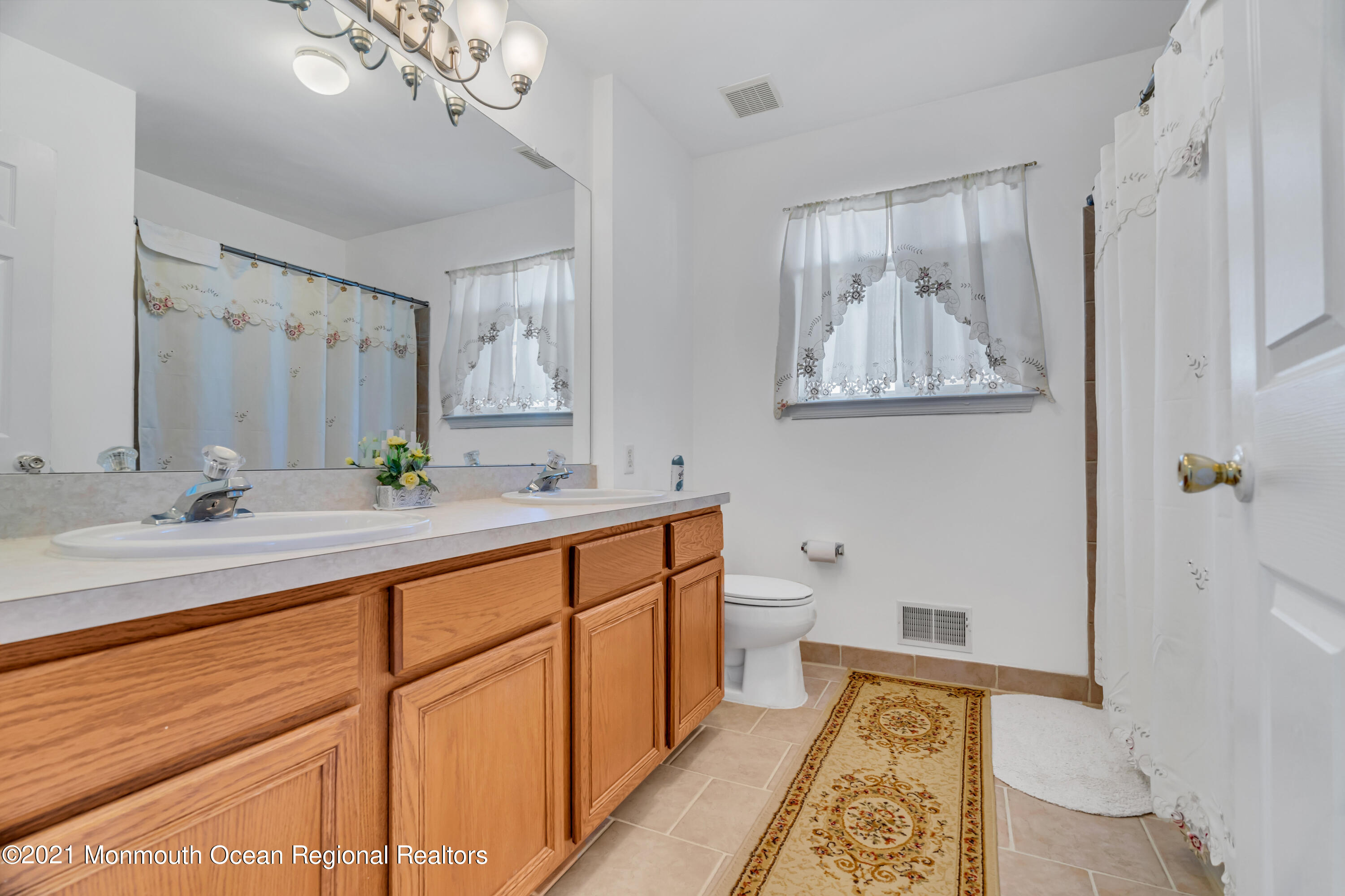 20 Lancaster Way Jackson, NJ 08527 - Photo 39 of 58 a spacious bathroom with double vanity sink a mirror and a shower