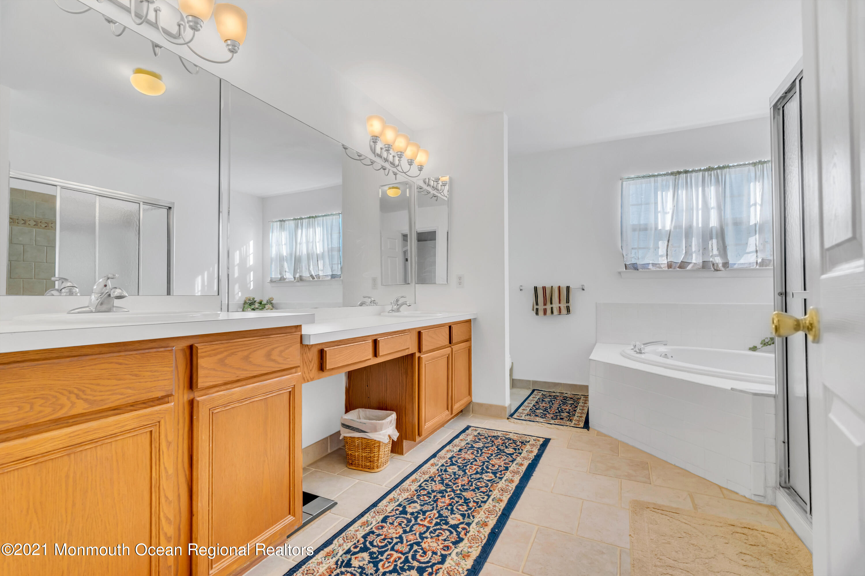20 Lancaster Way Jackson, NJ 08527 - Photo 43 of 58 a spacious bathroom with a sink a mirror and a bathtub