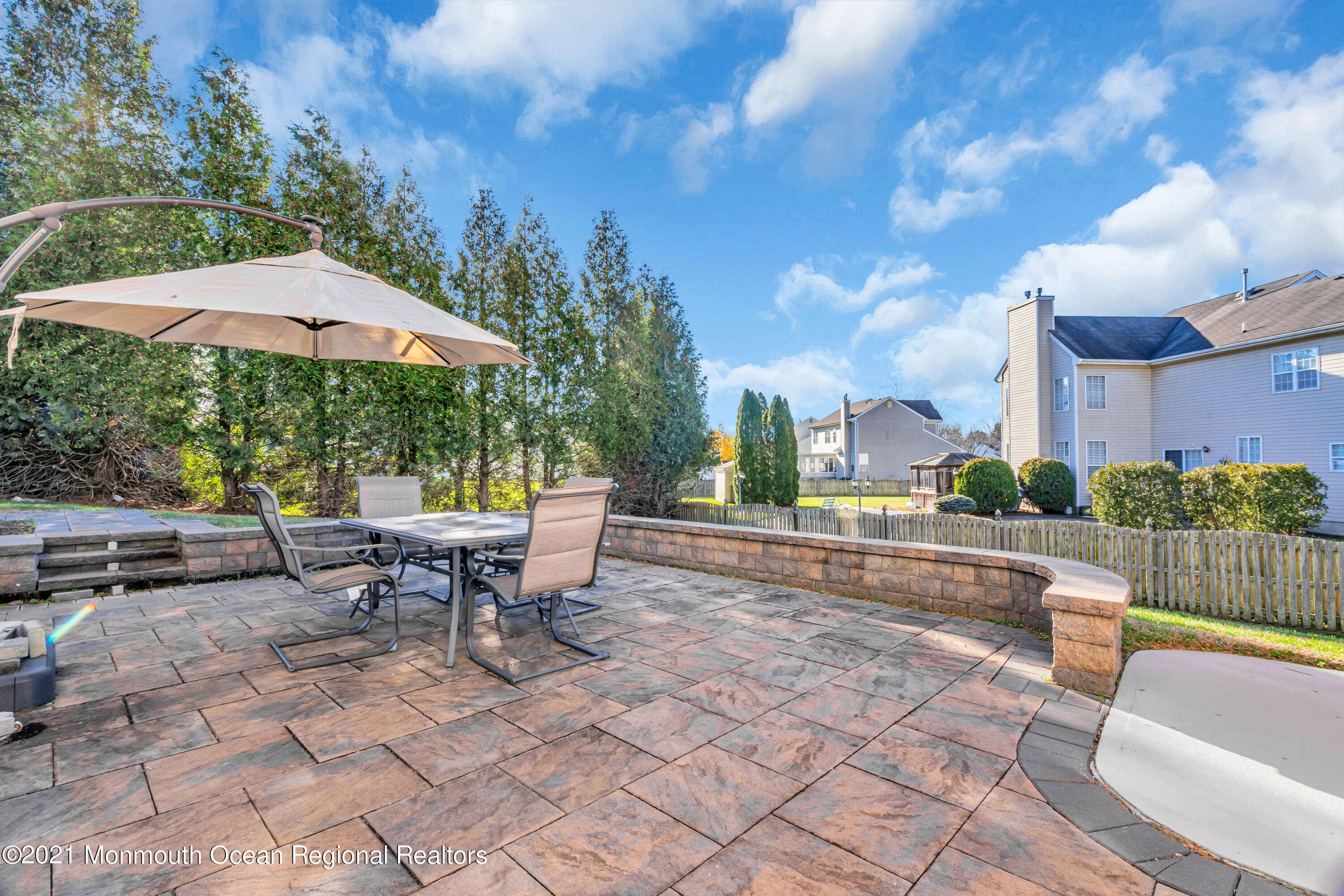 20 Lancaster Way Jackson, NJ 08527 - Photo 57 of 58 a view of a patio with a table and chairs under an umbrella