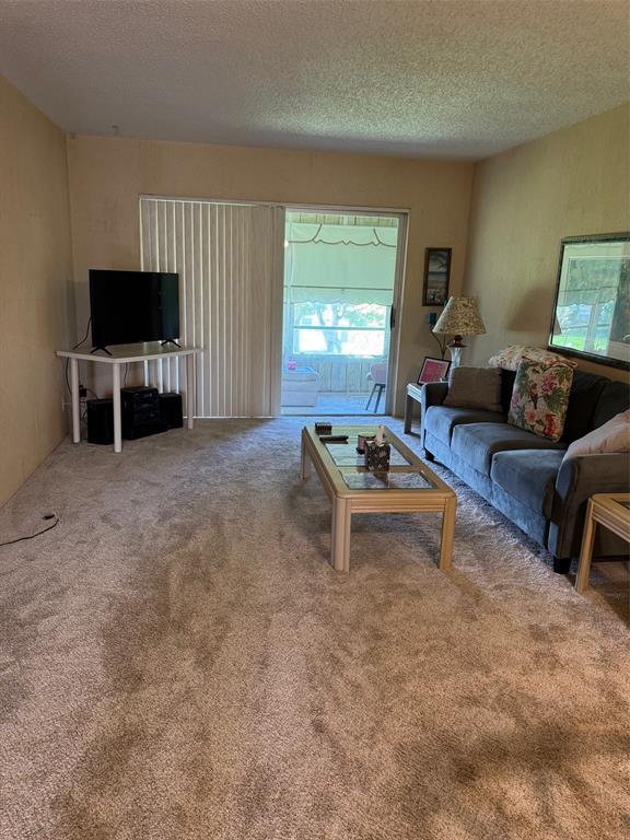 1801 Northwest 75th Avenue, Unit 306 Plantation, FL 33313 - Photo 11 of 27 a living room with furniture a flat screen tv and a window