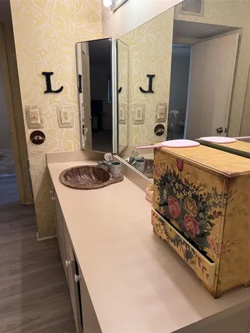 a bathroom with a sink a mirror and a shower