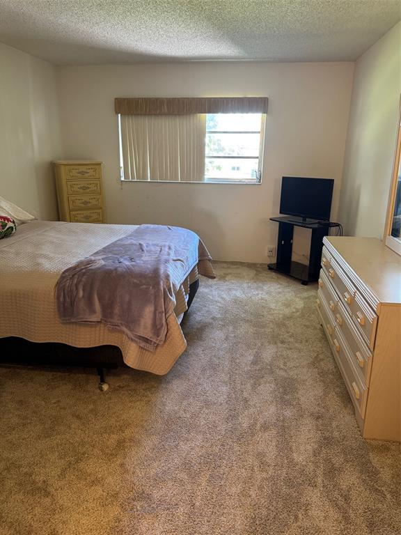 1801 Northwest 75th Avenue, Unit 306 Plantation, FL 33313 - Photo 17 of 27 a spacious bedroom with a bed and a window