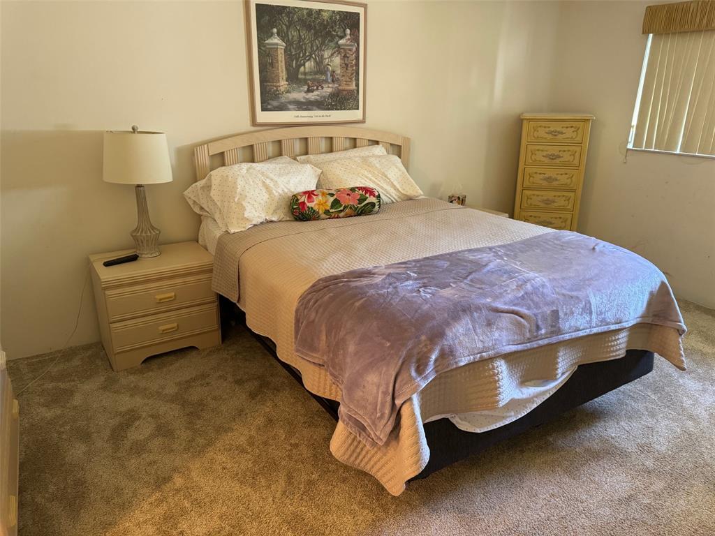 1801 Northwest 75th Avenue, Unit 306 Plantation, FL 33313 - Photo 18 of 27 a bedroom with a bed and lamp on dresser