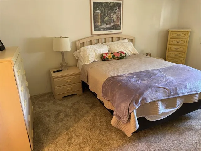 a bedroom with a bed and wall painting