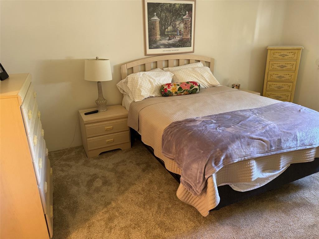 1801 Northwest 75th Avenue, Unit 306 Plantation, FL 33313 - Photo 20 of 27 a bedroom with a bed and wall painting