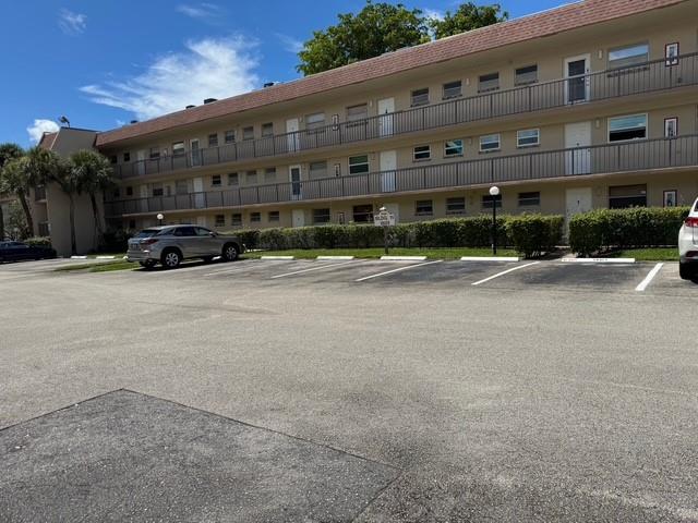 1801 Northwest 75th Avenue, Unit 306 Plantation, FL 33313 - Photo 2 of 27 a tall building with large windows