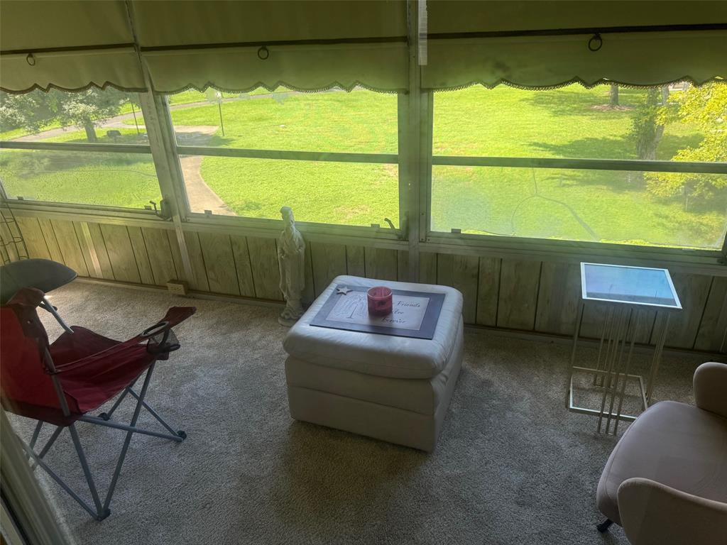 1801 Northwest 75th Avenue, Unit 306 Plantation, FL 33313 - Photo 24 of 27 a living room with a floor to ceiling window and a table
