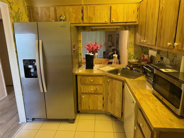 a kitchen with a sink and refrigerator