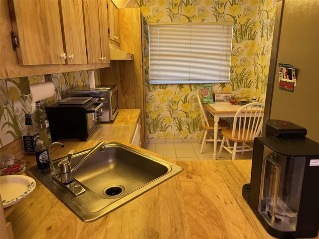 a room with wooden floor and a table chair