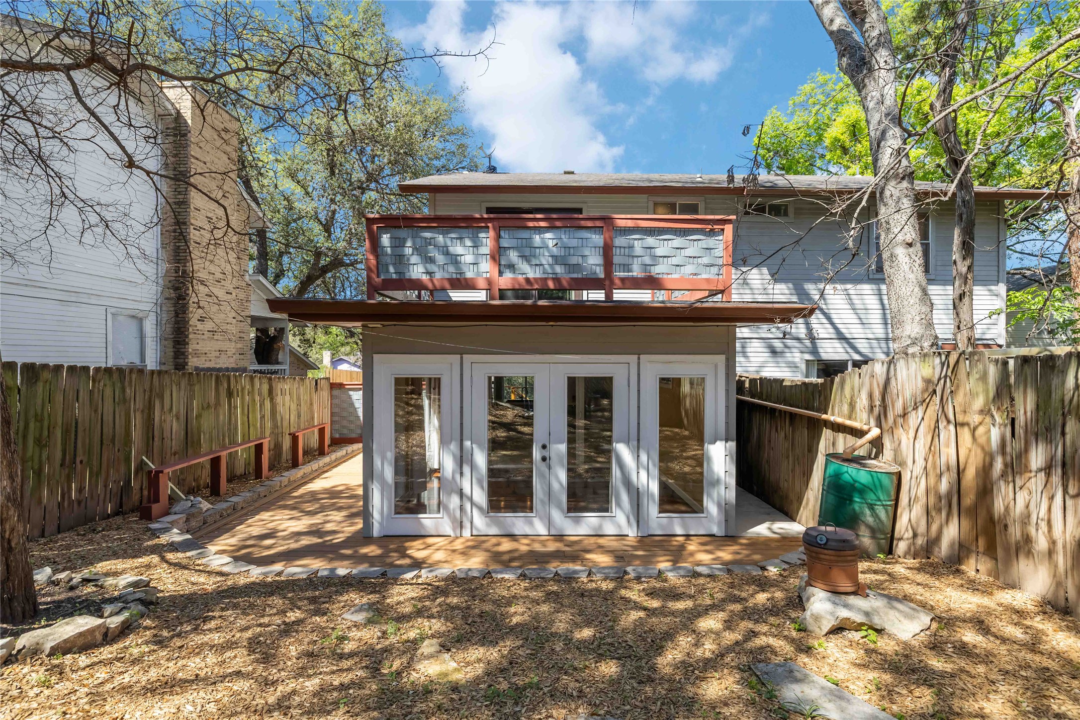 1703 Waterloo Trail, Unit B Austin, TX 78704 - Photo 28 of 36 Rear view of house with french doors, a fenced backyard, a balcony, and a patio area