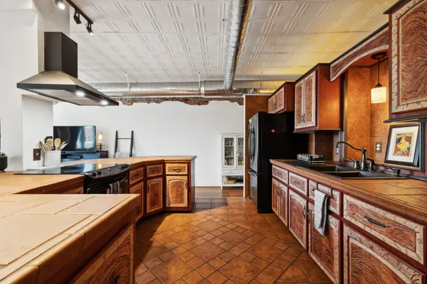 a kitchen with stainless steel appliances granite countertop a sink and cabinets