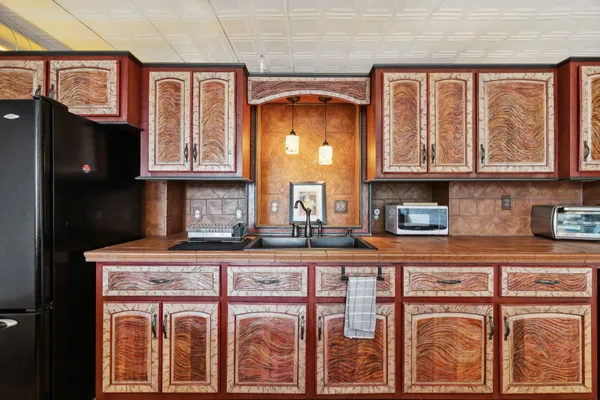 a kitchen with stainless steel appliances granite countertop a stove and cabinets