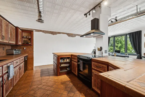a kitchen with stainless steel appliances granite countertop a sink and wooden cabinets
