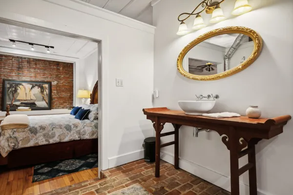 a bedroom with a bed and a mirror
