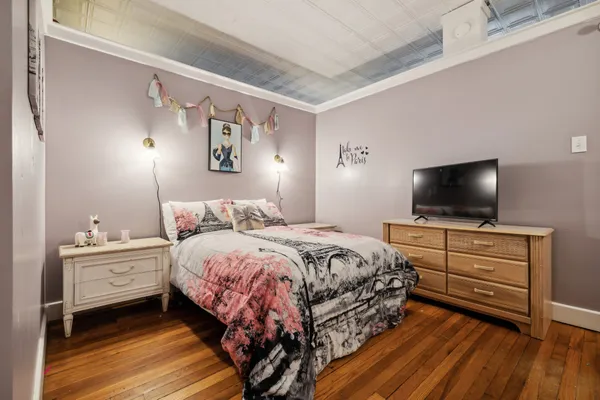 a bedroom with a bed and a flat screen tv