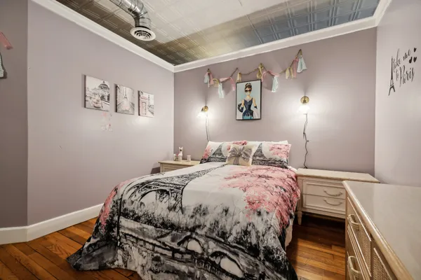 a bed sitting in a bedroom next to a window