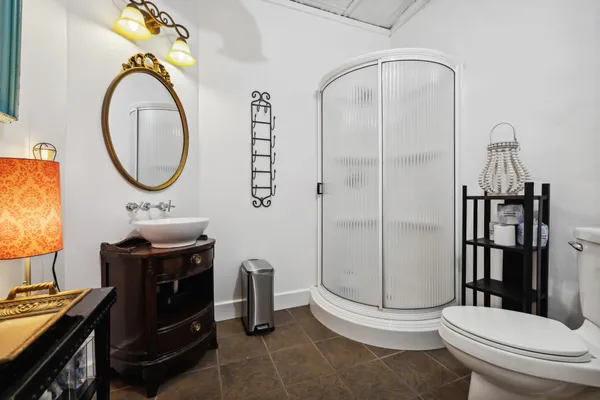 a bathroom with a toilet a sink and mirror