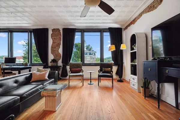 a living room with furniture fireplace and flat screen tv