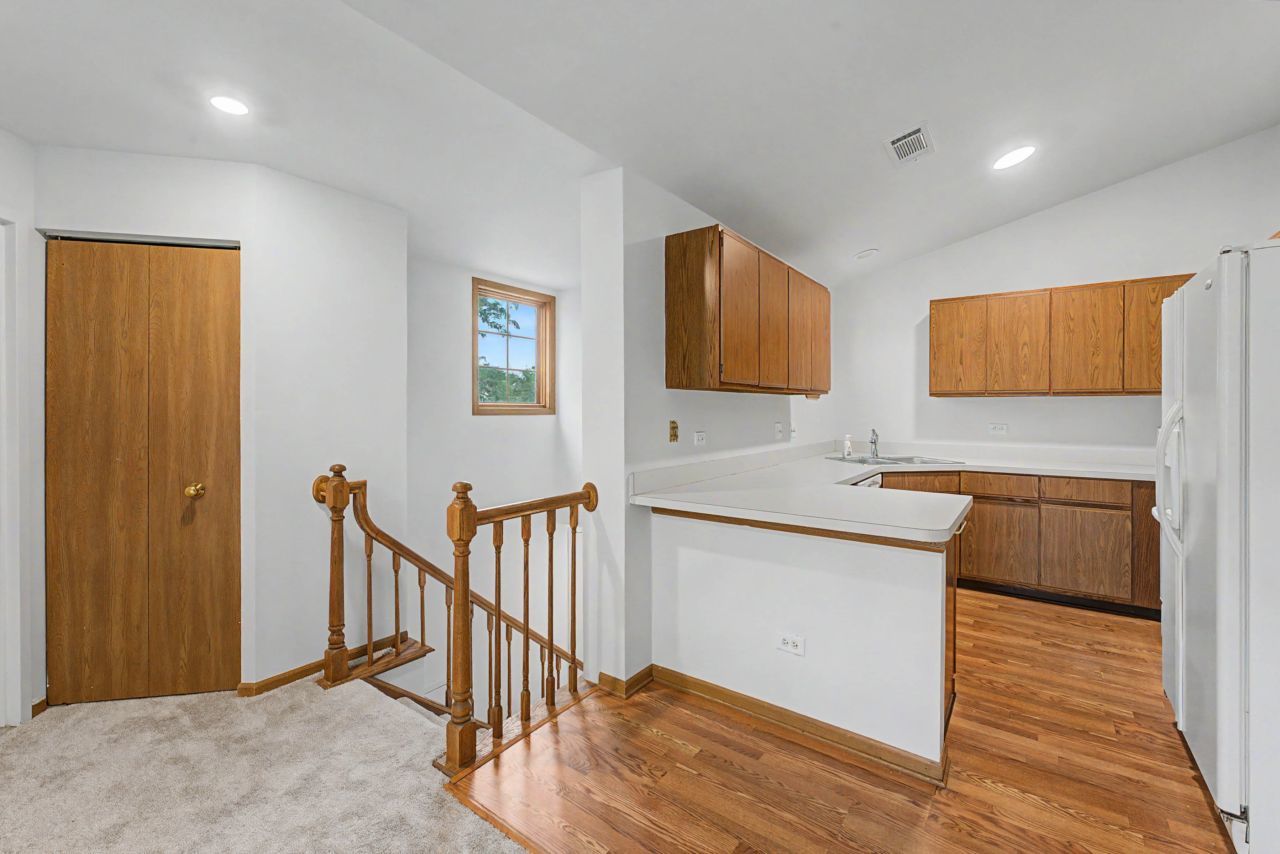 1953 North Coldspring Road Arlington Heights, IL 60004 - Photo 6 of 27 a kitchen with stainless steel appliances granite countertop a sink and cabinets