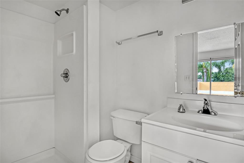 3514 Dairy Road, Unit 10 Titusville, FL 32796 - Photo 35 of 44 a bathroom with a sink a toilet and shower