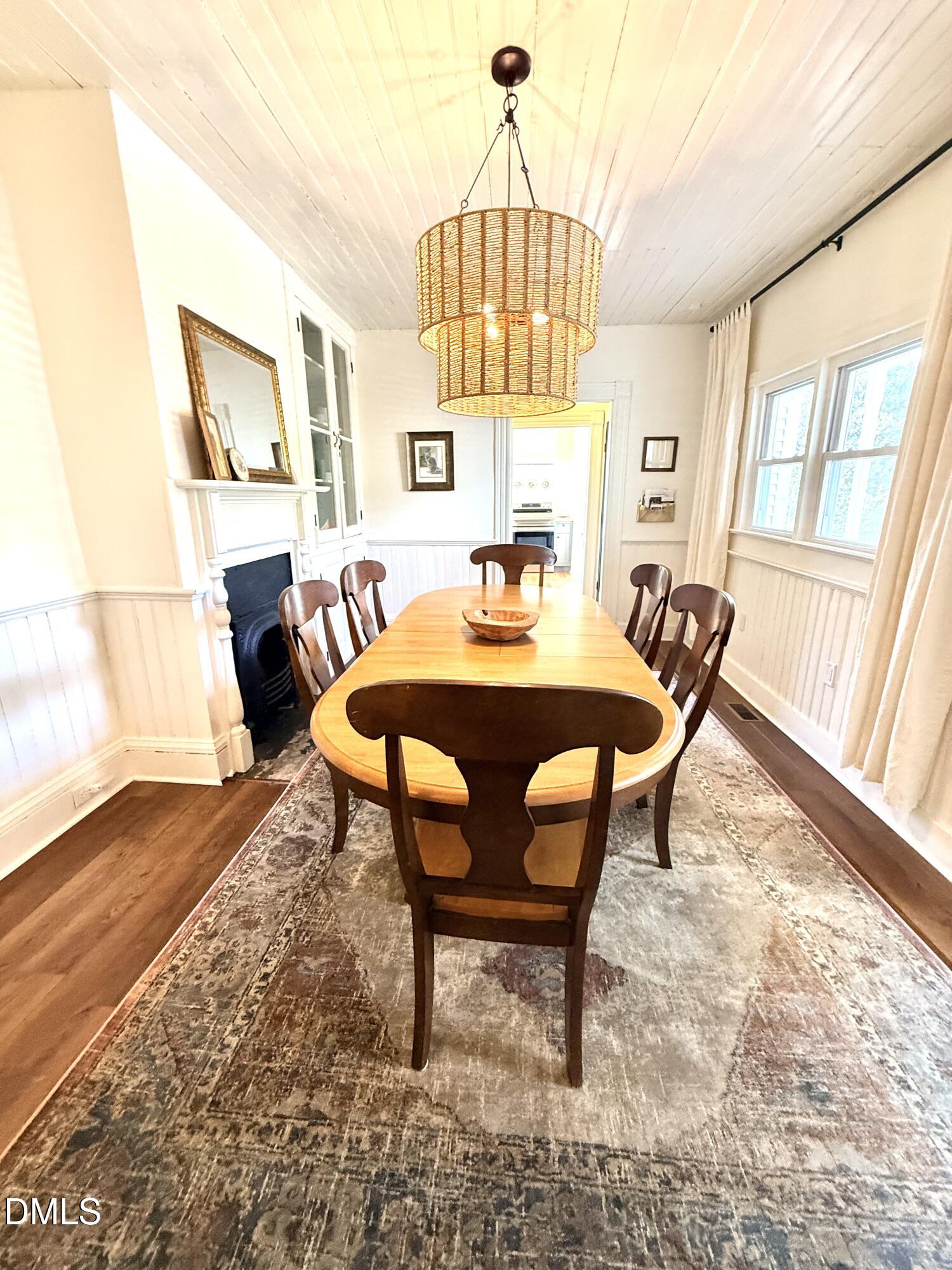 190 Broad Street Milton, NC 27305 - Photo 18 of 62 a dining room with furniture a chandelier and wooden floor