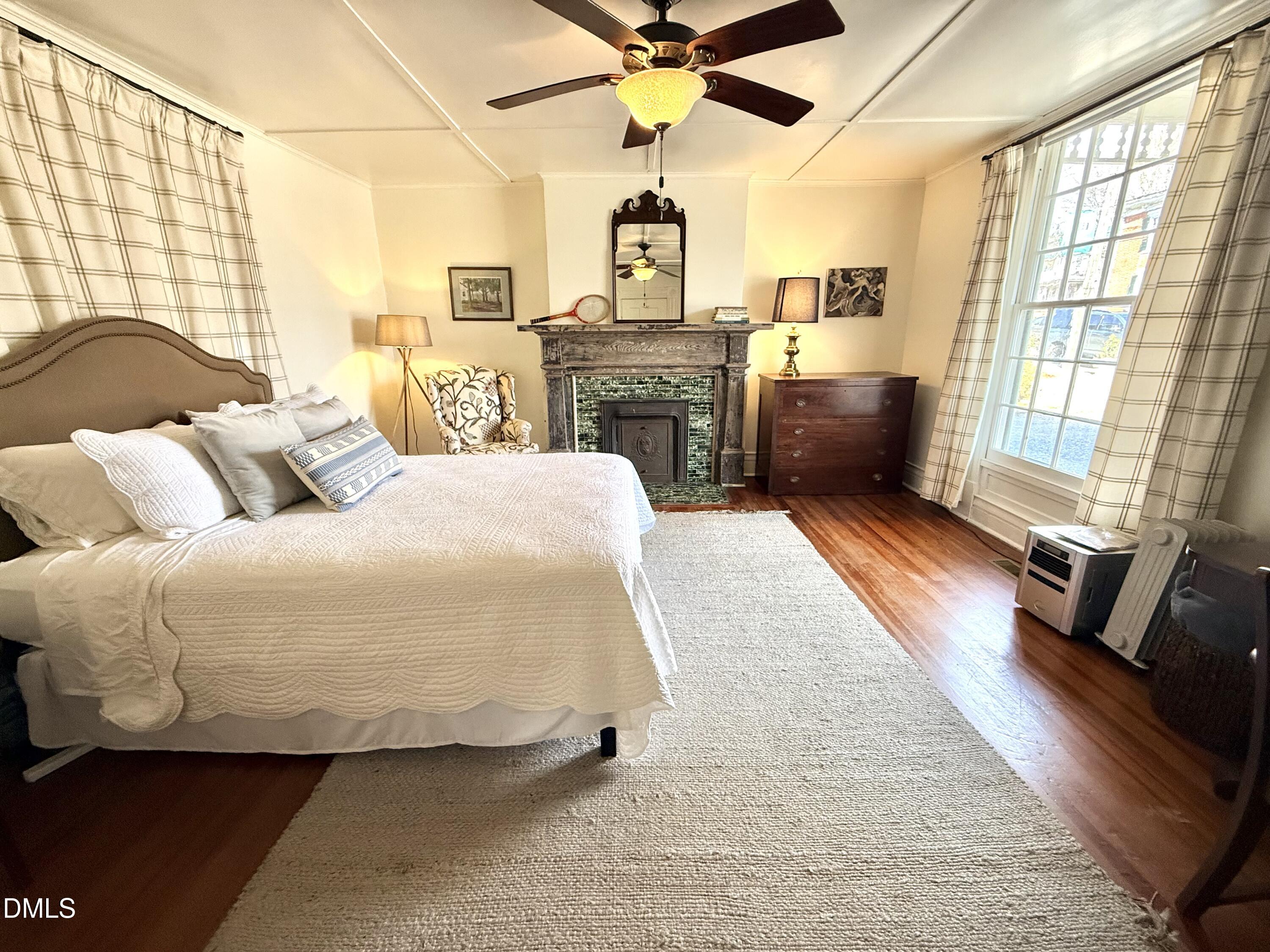 190 Broad Street Milton, NC 27305 - Photo 27 of 62 a bedroom with a bed and wooden floor