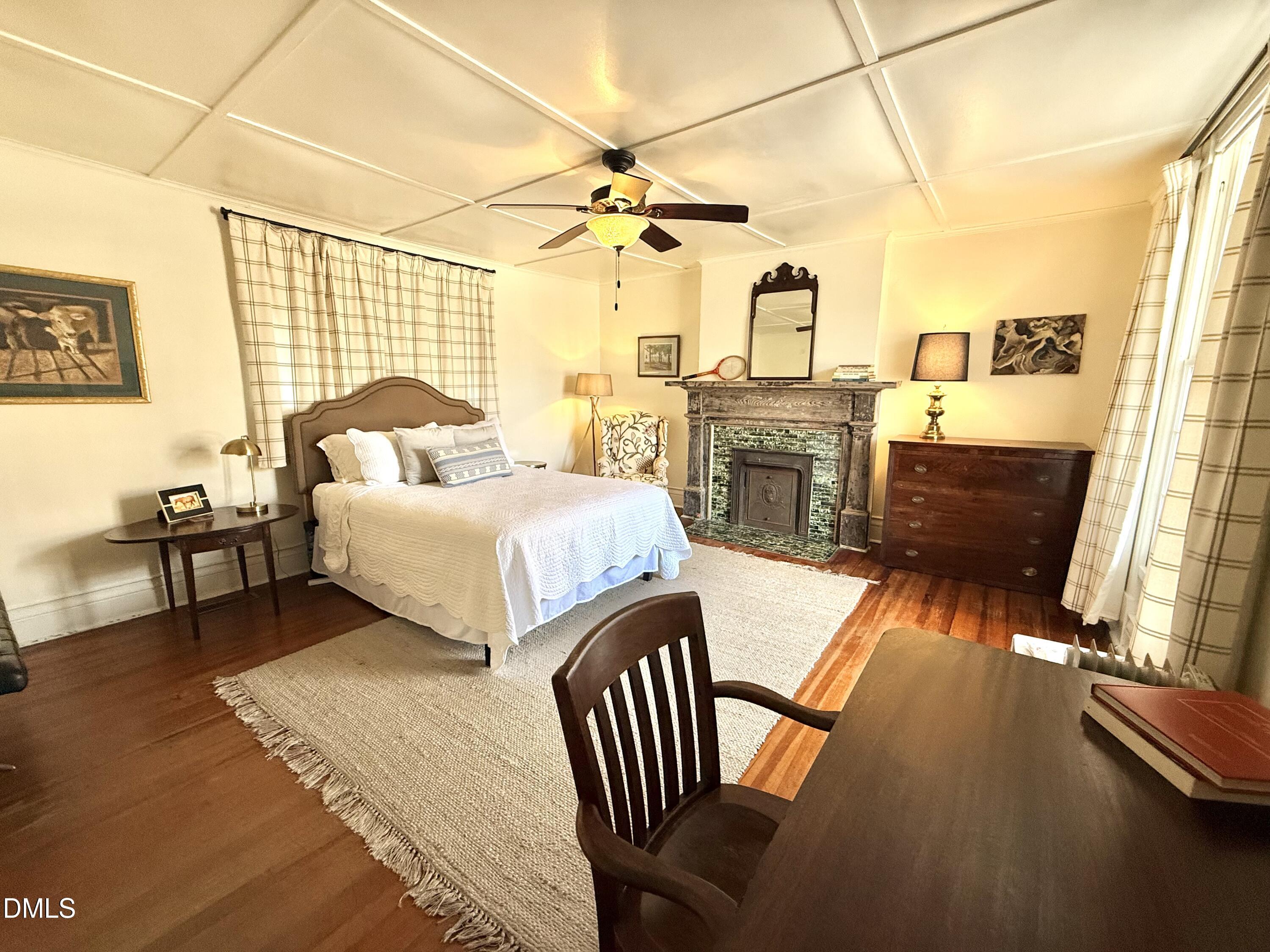 190 Broad Street Milton, NC 27305 - Photo 28 of 62 a bedroom with furniture and a fireplace