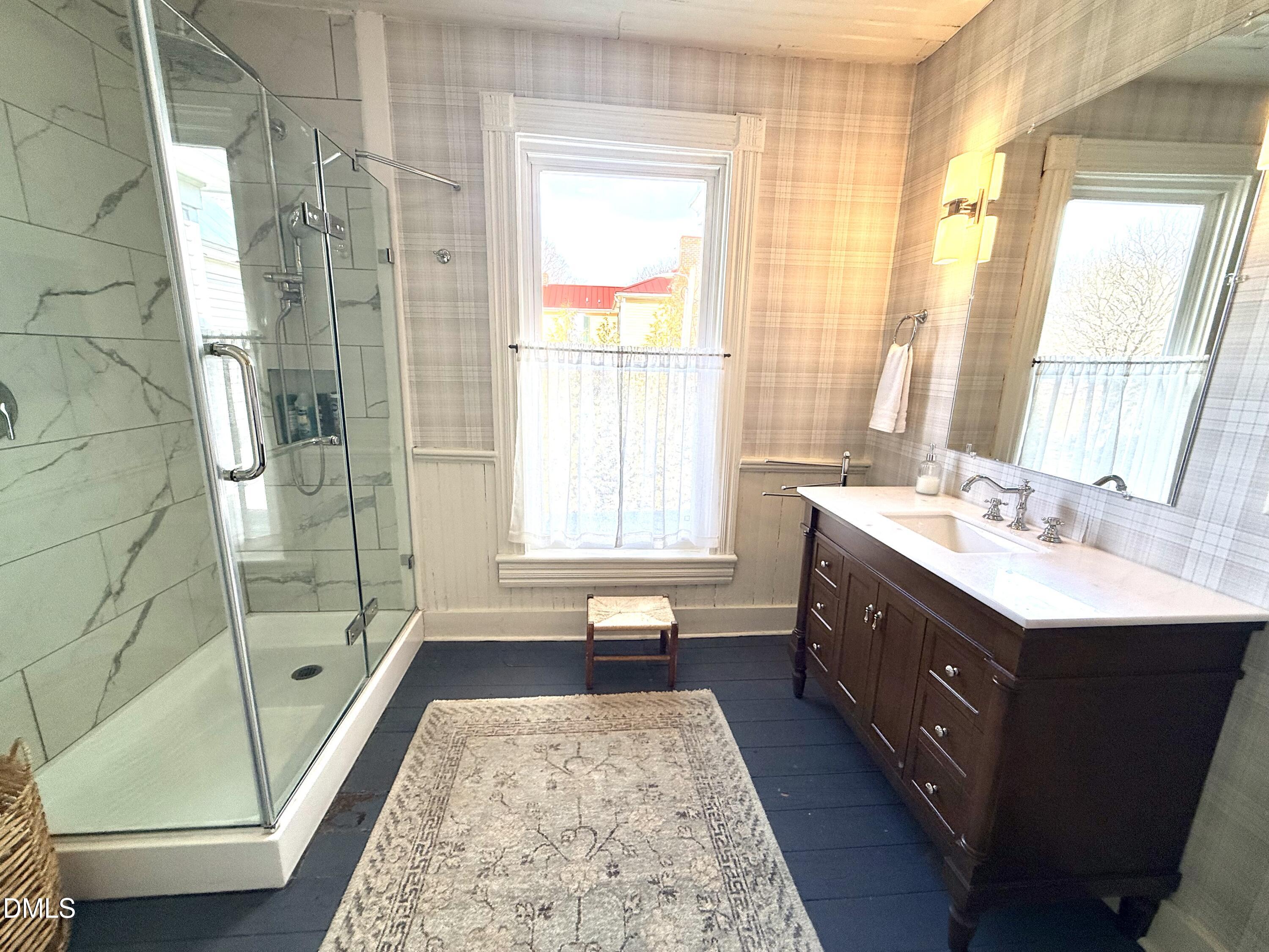 190 Broad Street Milton, NC 27305 - Photo 33 of 62 a bathroom with a double vanity sink and a tub