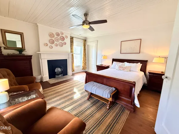a bedroom with a bed and a fireplace