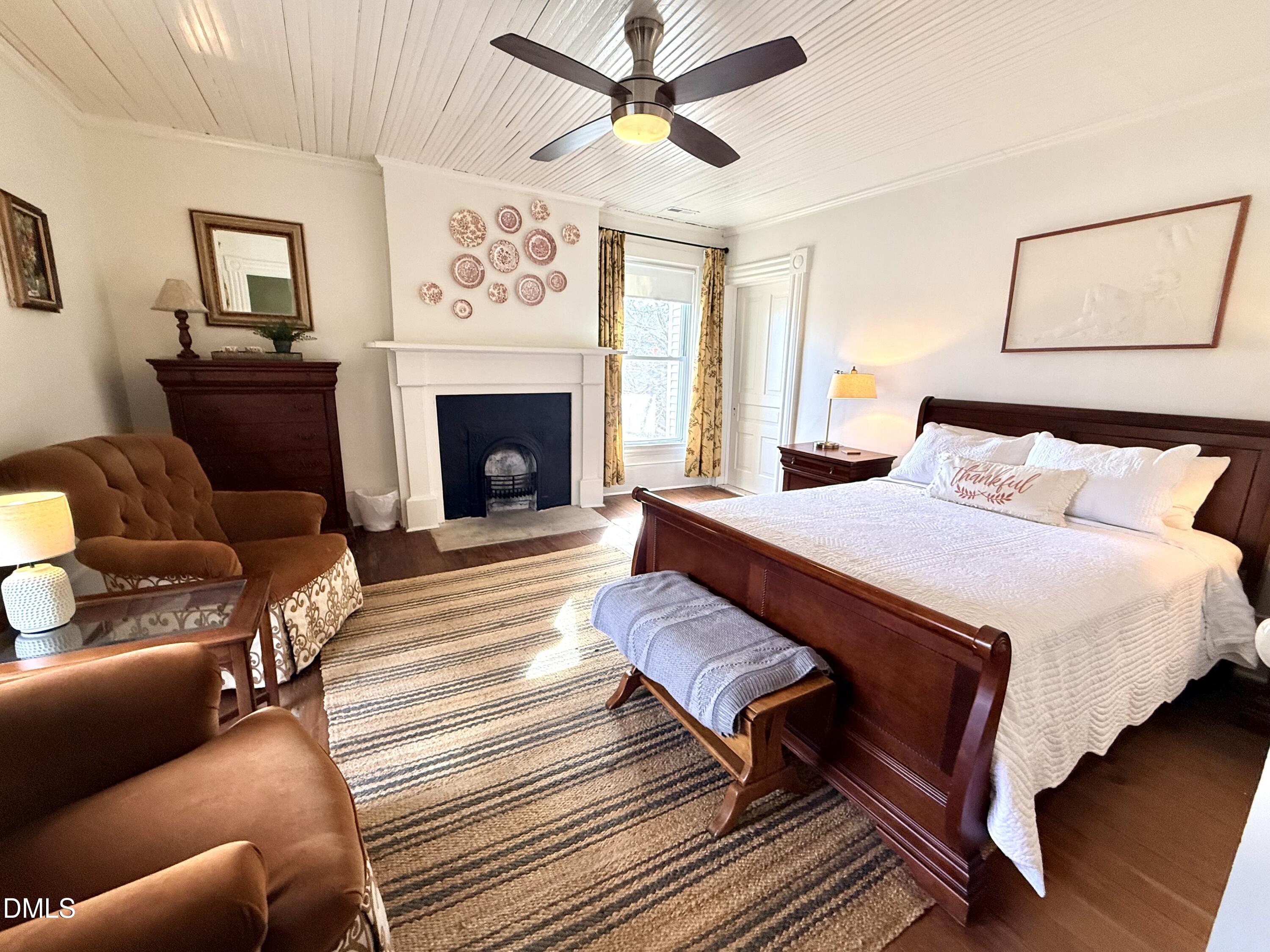 190 Broad Street Milton, NC 27305 - Photo 40 of 62 a spacious bedroom with a bed and a fireplace