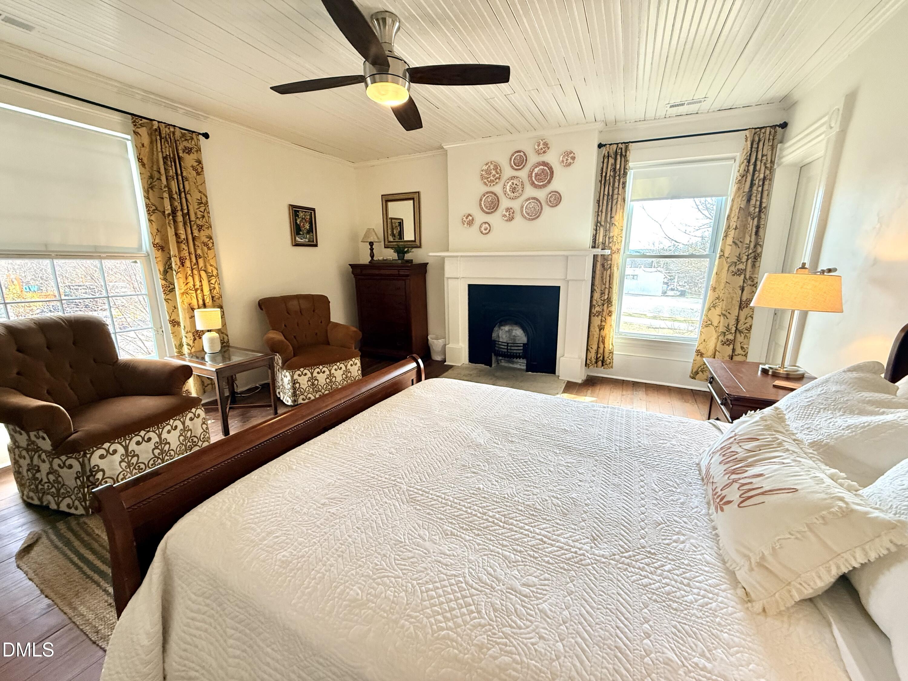 190 Broad Street Milton, NC 27305 - Photo 41 of 62 a spacious bedroom with a bed and a fireplace