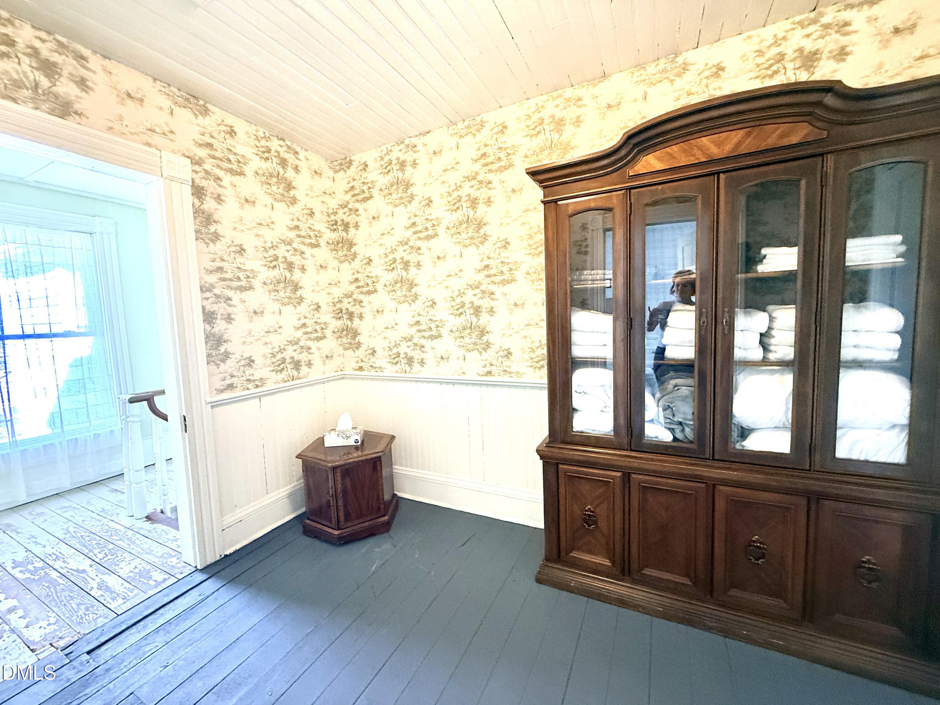 190 Broad Street Milton, NC 27305 - Photo 42 of 62 a view of an empty room with wooden floor and a window