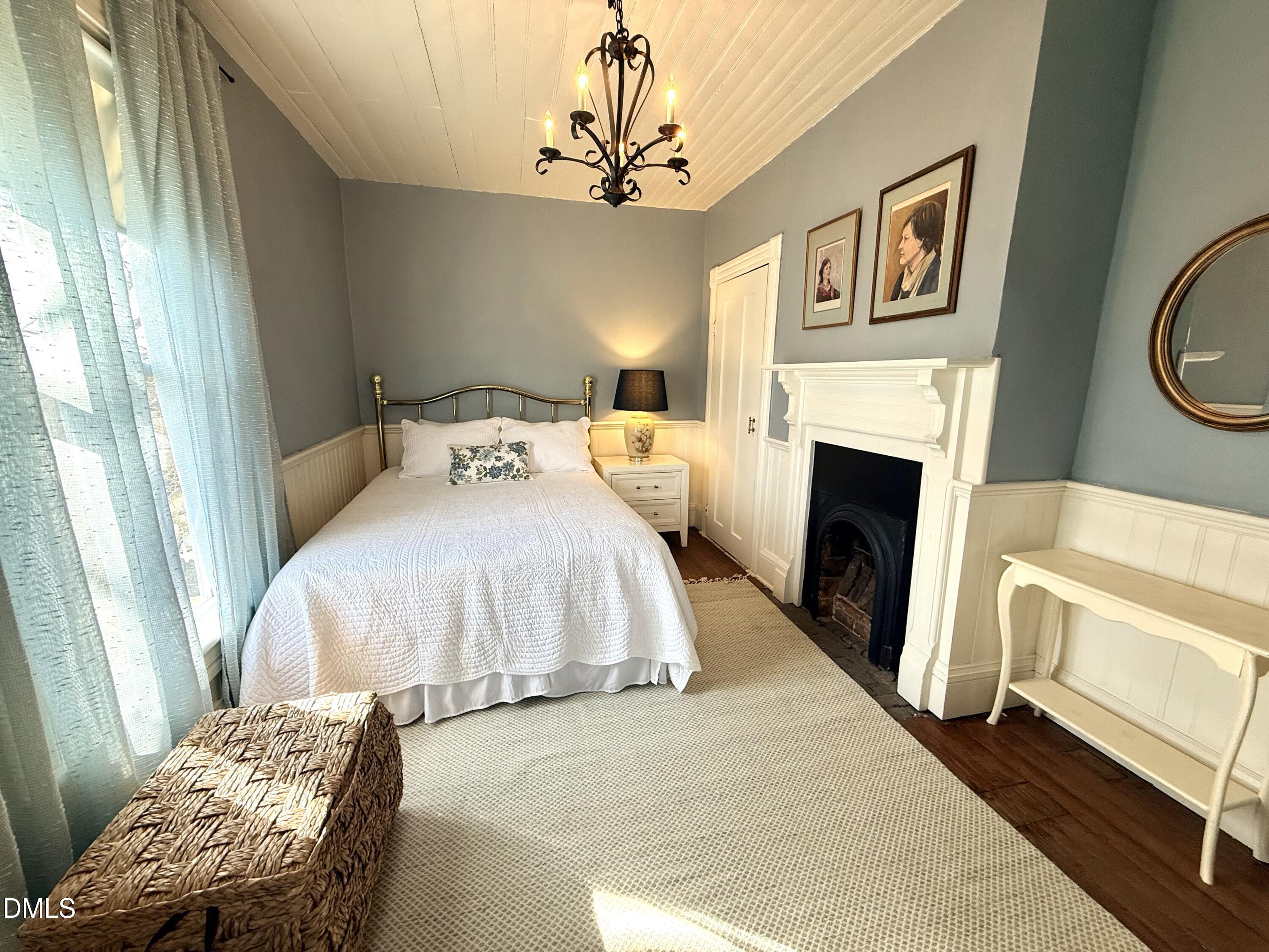 190 Broad Street Milton, NC 27305 - Photo 47 of 62 a bedroom with a bed and a fireplace