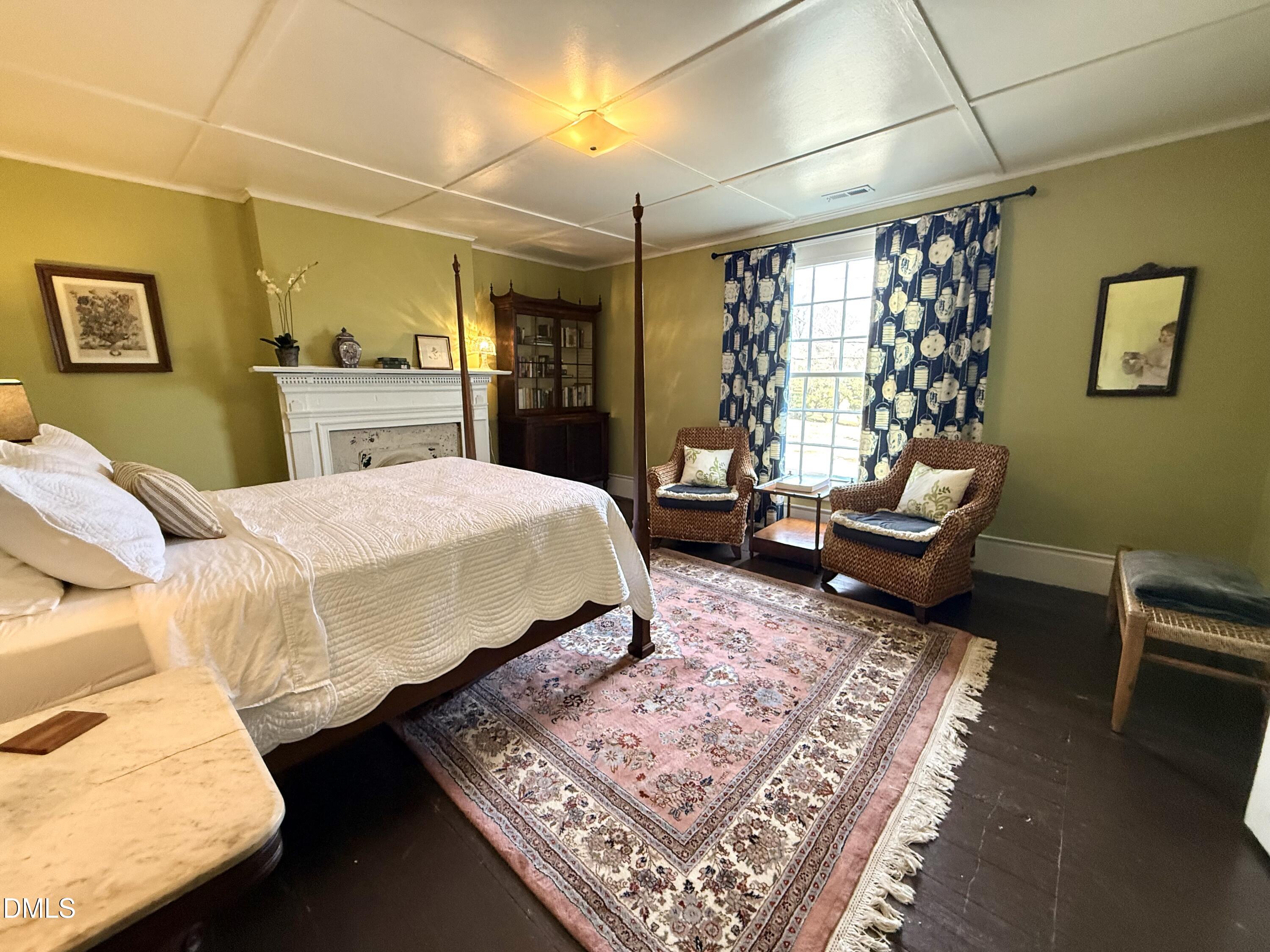 190 Broad Street Milton, NC 27305 - Photo 50 of 62 a spacious bedroom with a bed a couch and dresser