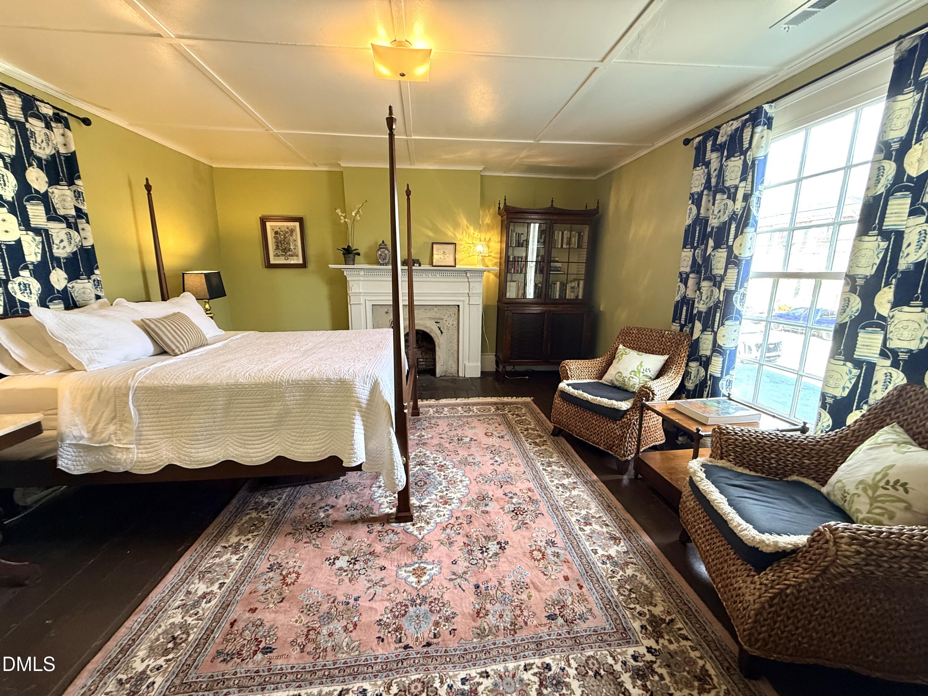 190 Broad Street Milton, NC 27305 - Photo 51 of 62 a bedroom with a bed a couch and wooden floor